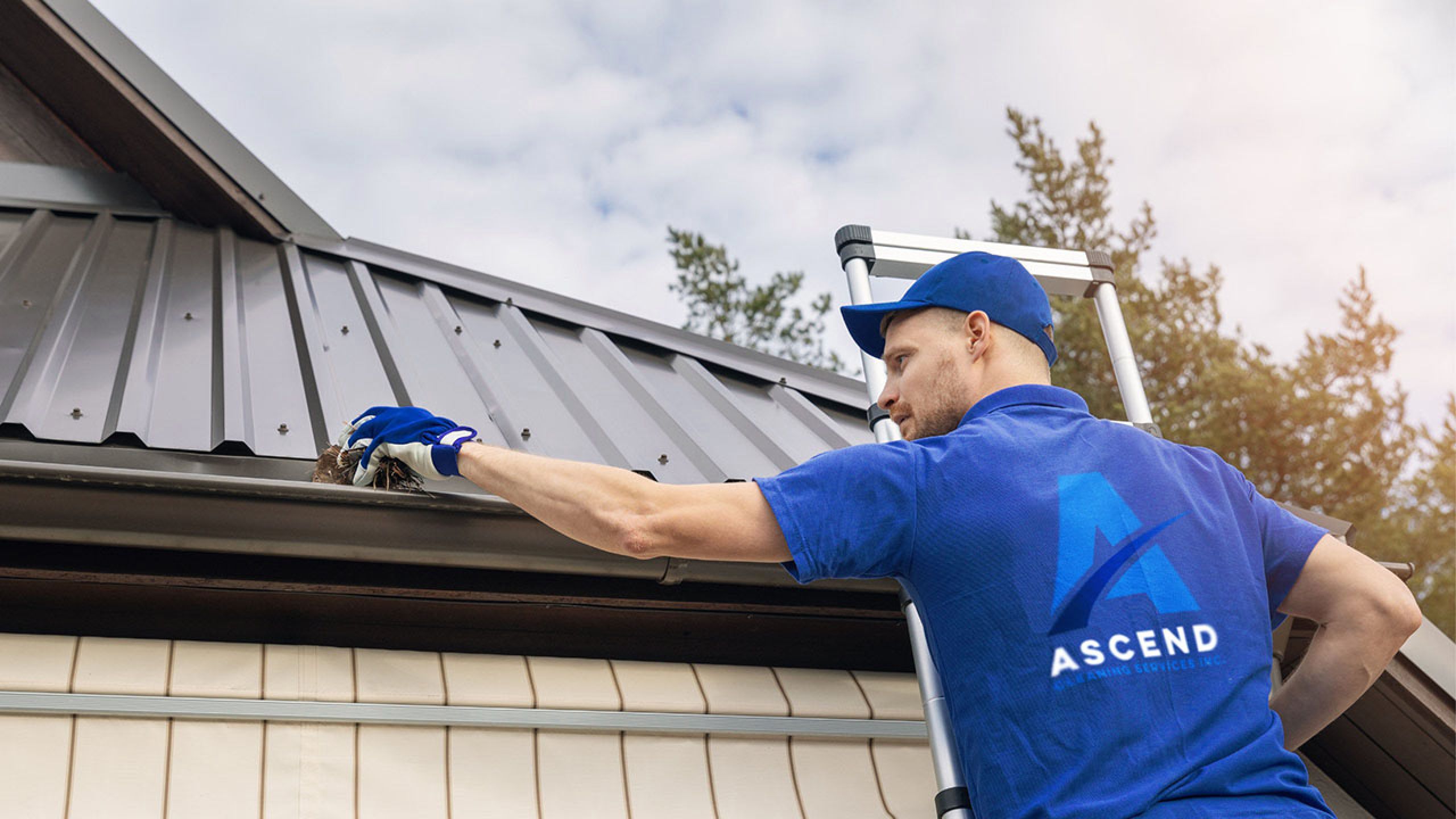 Ascend gutter cleaning team cleaning gutters on building Ascend Cleaning Services Inc.